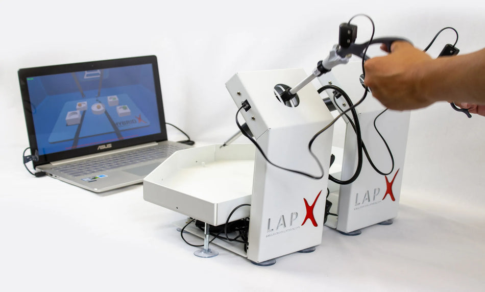 Hybrid laparoscopic trainer combining virtual reality and box simulator for surgical skills
